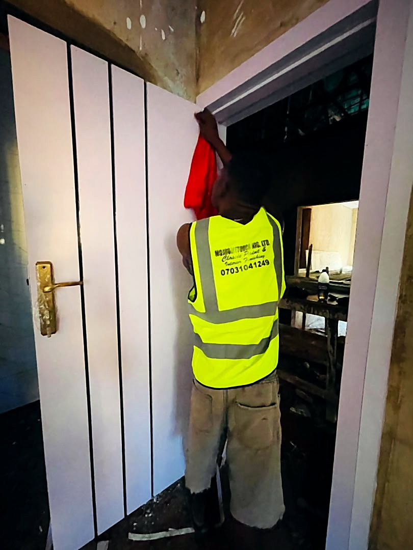 Mojhometouch crew member finishing a panelled door