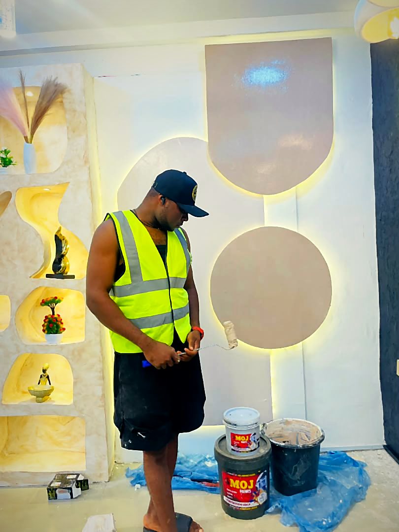Mojhometouch painter finishing a lit feature wall